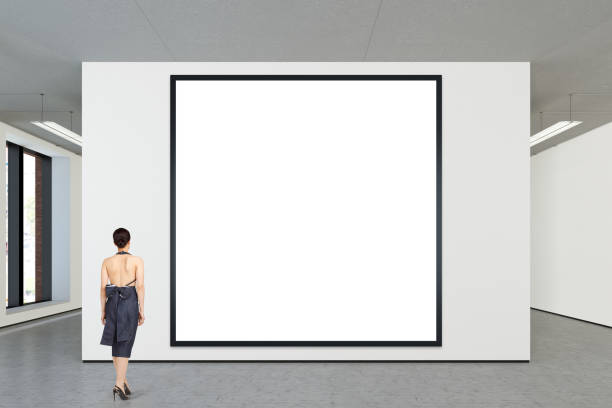 istock Woman looking at blank poster in modern gallery 846018246