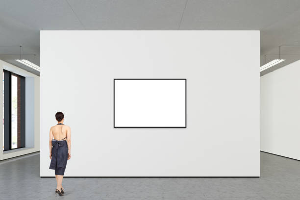 istock Woman looking at blank poster in modern gallery 846018382