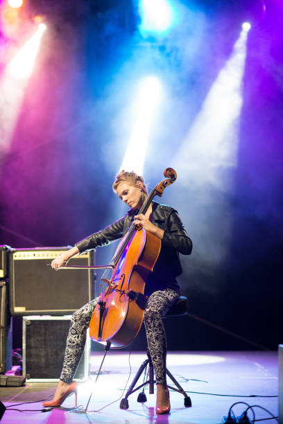 istock Young female musician playing cello on stage 846022236