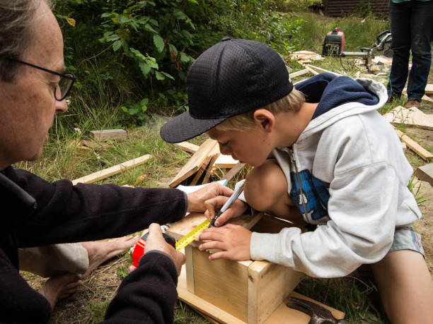 istock Boy learning how to build a birdhouse 846025250