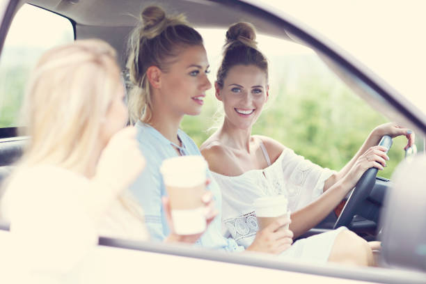 istock Young women traveling by car with map 846028414