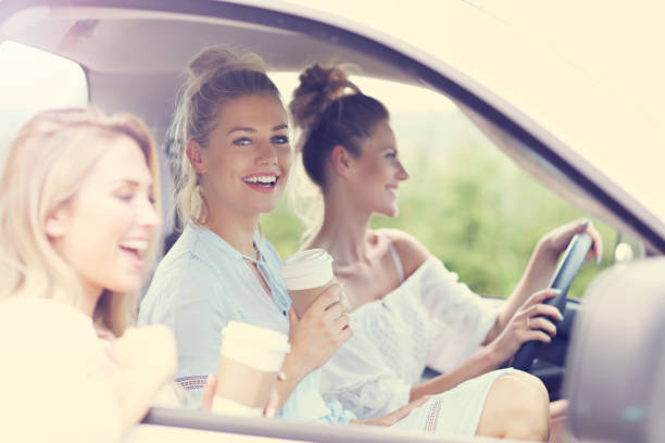 istock Young women traveling by car with map 846028508