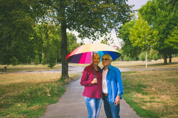 istock The old couple in the rain with umbrellas 846028536