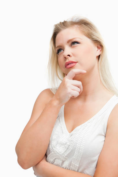 istock Thoughtful blonde woman looking up while standing 846029094
