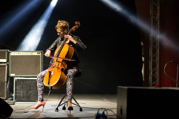 istock Young female musician playing cello on the concert 846029544