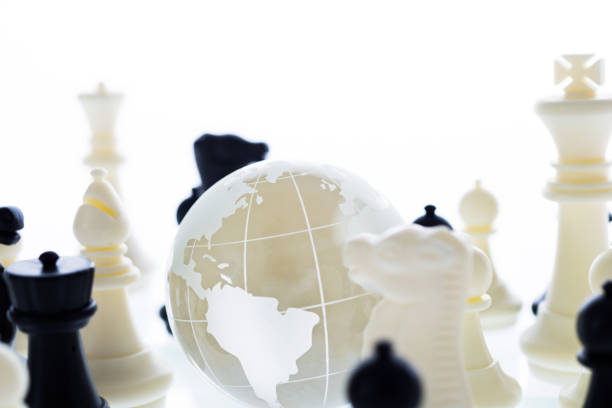istock Chess pieces and glass earth globe 846032850
