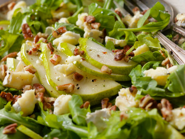 Arugula, Pear and Brie Salad with Walnuts Arugula, Pear and Brie Salad with Walnuts and Herb Oil Dressing vinegar stock pictures, royalty-free photos & images
