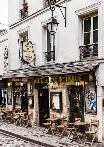 Paris, France - July 06, 2017: The charming cafe La Taverne de Montmartre on Montmartre hill. Montmartre with traditional french cafes and art galleries is one of the most visited landmarks in Paris.