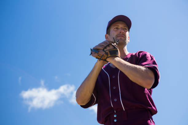 istock Low angle view of baseball pitcher standing against blue sky 846033736