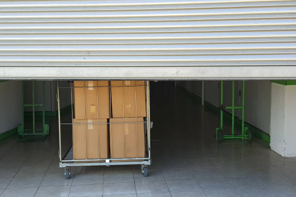 istock Entrance into self storage units, big cart with boxes in front, metal gate 846034032