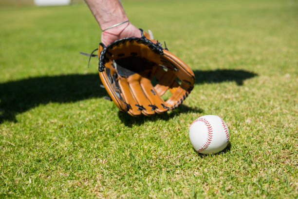 istock Hand of baseball pitcher by ball on field 846036616