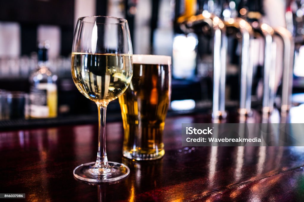 Close up of a glass of wine and a beer Close up of a glass of wine and a beer in a bar Beer - Alcohol Stock Photo