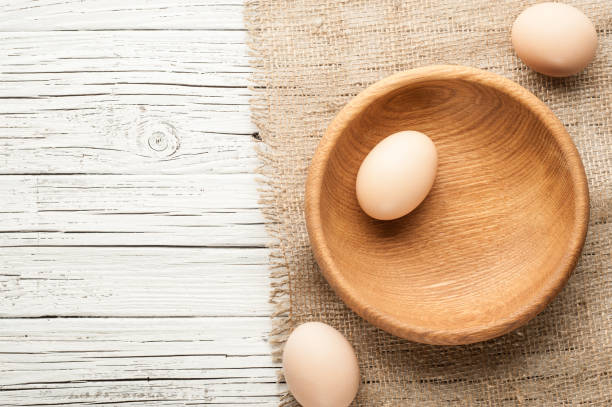 istock chicken eggs in wooden plate on white wooden background 846037610