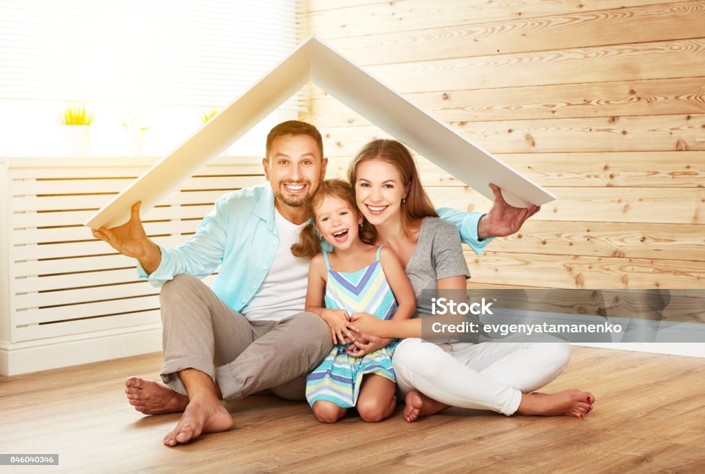 concept housing   young family. Mother father and child in new house with  roof concept housing a young family. Mother father and child in new house with a roof Home Insurance Stock Photo
