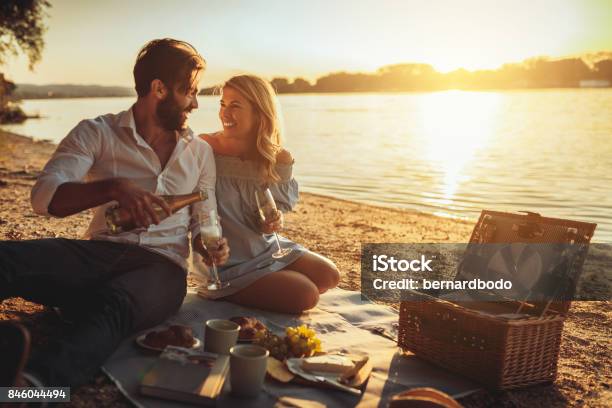 Celebrating Our Relationship Stock Photo - Download Image Now - Picnic, Couple - Relationship, Sunset