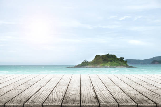istock Empty wooden table with party on beach background blurred. 846047360