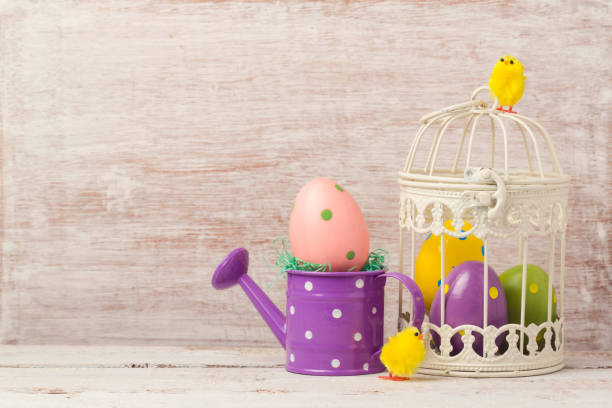 istock Easter holiday concept with egg decoration in bird cage on wooden table 846054974