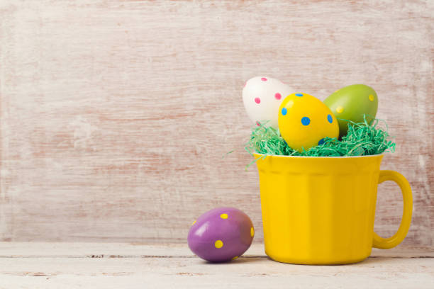istock Easter holiday concept with egg decoration in yellow cup over rustic background 846054976