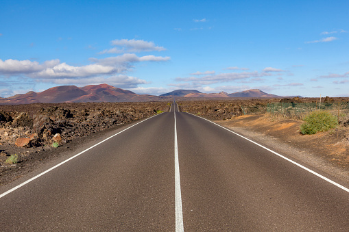 lonely road on lanzarote island, canary islands, spain.