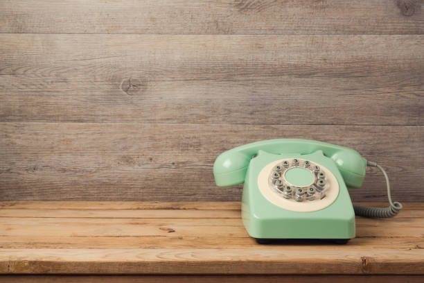 istock Retro telephone on wooden table. Call center or support service concept background 846055286