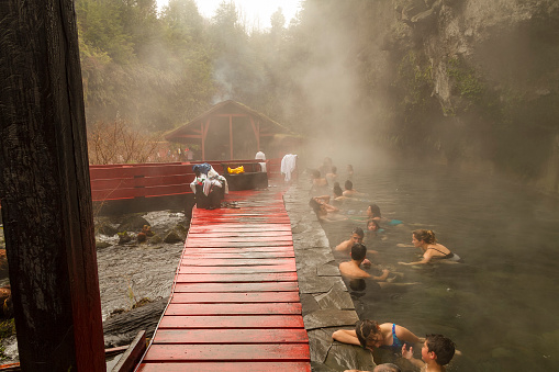 Panguipulli, Chile - September 17, 2016: People enjoying hot water springs in the middle of nature very close to Villarica Volcano and the lake of the same name in southern Chile.