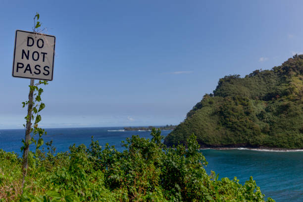 Littering Highways Unlawful Sign and buckle up sign Kauai, Hawaii USA