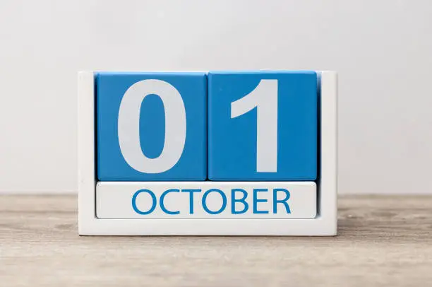 October 1st . October 1 white and blue wooden calendar on light wood abstract background. Autumn day.