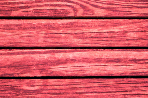 Bright red colored wooden background. Toned wood planks template. Rough timber natural ornament. Wooden board of table or floor. Rustic wood texture for vintage banner template. Shabby chic design