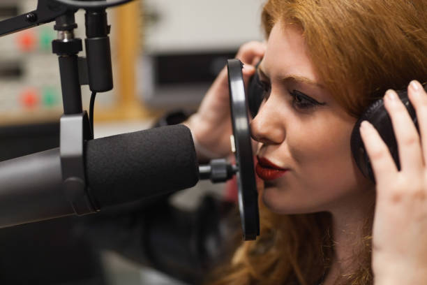 istock Focused beautiful singer recording a song 846062432