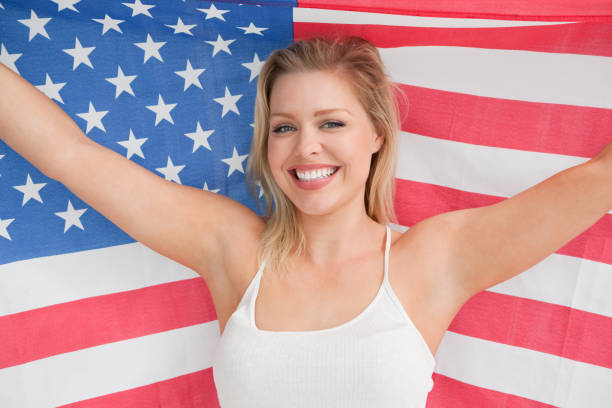 istock Smiling woman raising the American flag 846067896