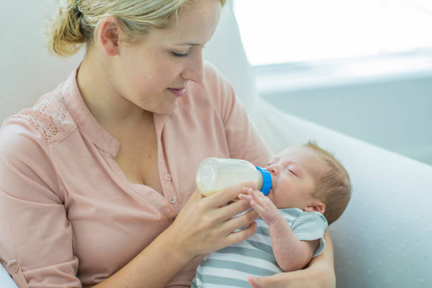 istock Young Mother Feeding Newborn Son 846068012