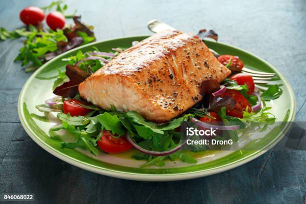 Baked Salmon Steak With Tomato Onion Mix Of Green Leaves Salad In A Plate Healthy Food Stock Photo - Download Image Now