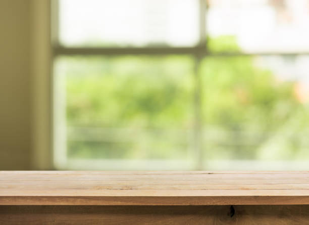 istock Wood table top on blur green garden from window view. 846068286
