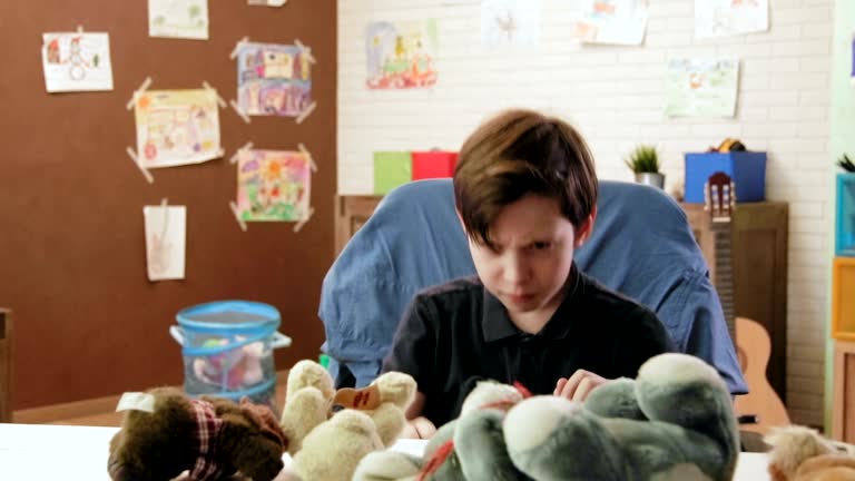 Angry boy making mess in his room throwing stuffed toys, shows his anger