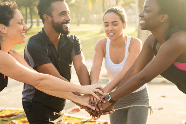 istock Happy multi-ethnic sporty friends stacking hands at park 846075506