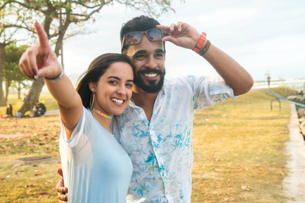 istock Happy woman pointing while standing with man at park 846075702