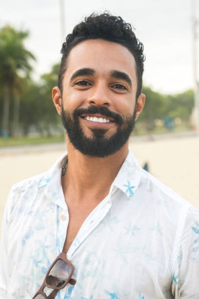 istock Portrait of confident young man at beach 846077950
