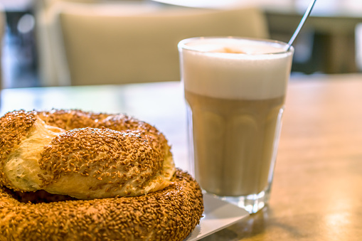 Turkish traditional sesame bagels. Simit and latte macchiato in the cafe