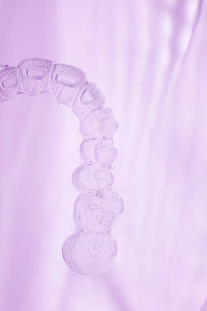 istock Invisible orthodontics cosmetic brackets tooth aligners plastic braces modern teeth retainers isolated closeup. 846079380