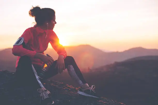 Photo of Fit woman athlete resting outdoors