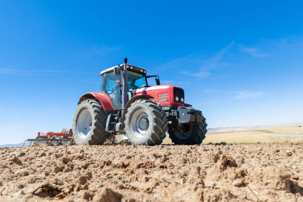 istock agricultural tractor in the foreground with blue sky background 846086522