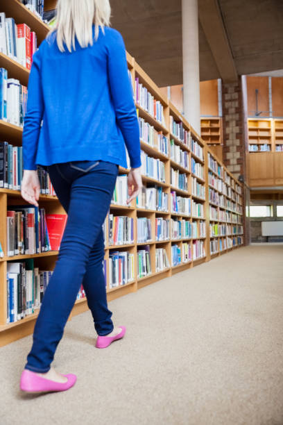 istock Female student walking in the library 846087036