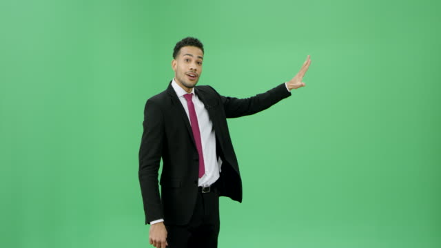 Multi ethnic man in a dark suit presenting weather news