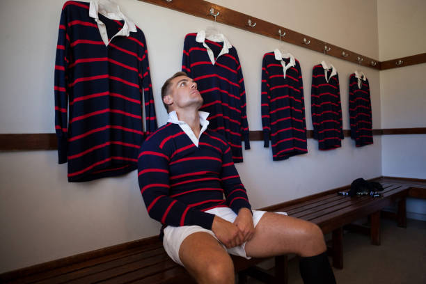 Tired player wearing jersey sitting on bench