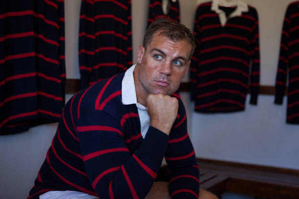istock Thoughtful rugby player sitting on bench in room 846087622