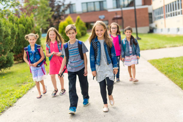 great portrait of school pupil outside classroom carrying bags - junior high fotos imagens e fotografias de stock