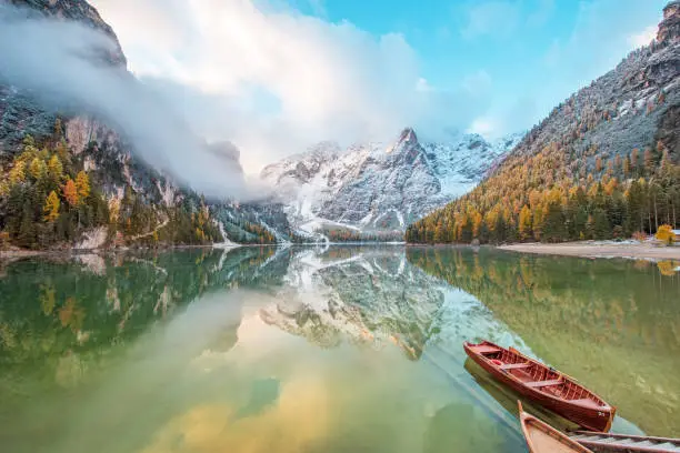 Photo of Magical beautiful fairy autumn landscape with boats on the lake on Fanes-Sennes-Braies natural park in the Dolomites in South Tyrol, Alps, Italy, Europe. (mental vacation, holiday, inner peace, harmony - concept)