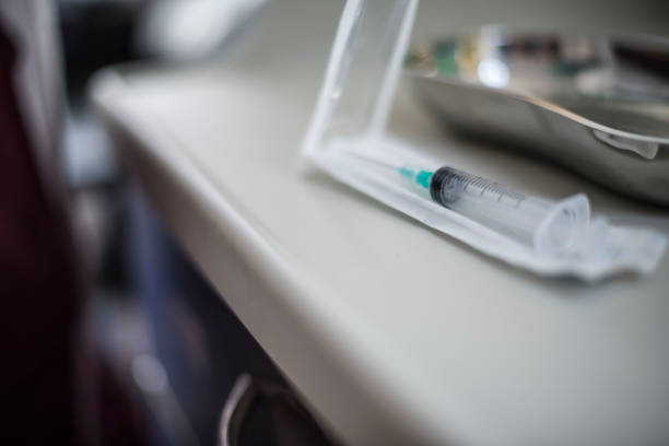 Doctor prepare a syringe for vaccination Doctor prepare a syringe for vaccinate a young girl malaria blood sample stock pictures, royalty-free photos & images