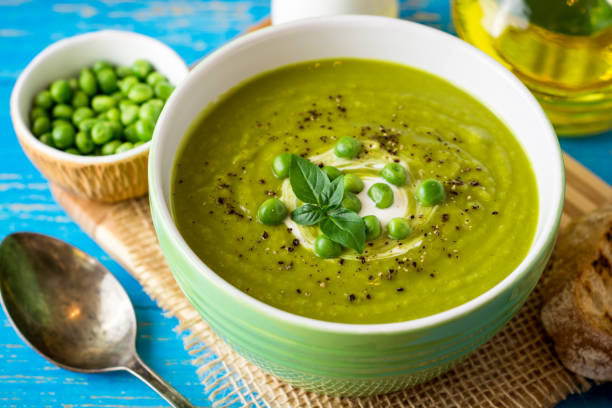 istock Green pea soup in bowl on wooden table 846112474
