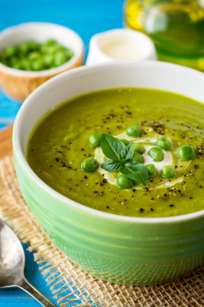 istock Green pea soup in bowl on wooden table 846112922